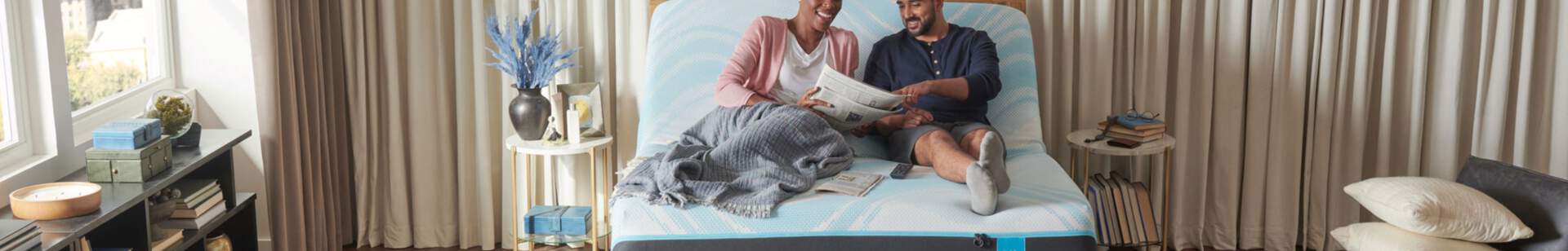 People laying on a tempur-pedic mattress laughing