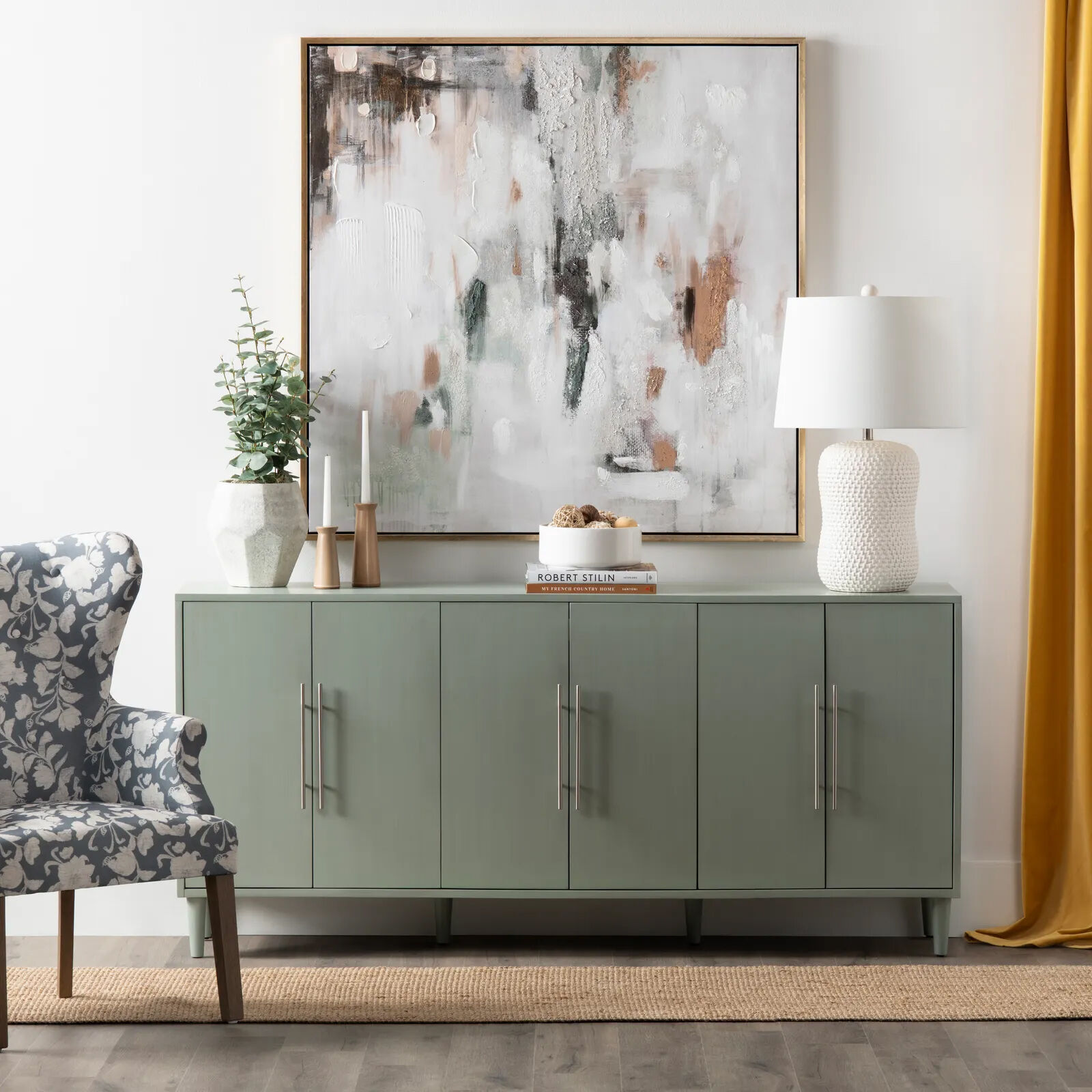 art hung above green cabinet