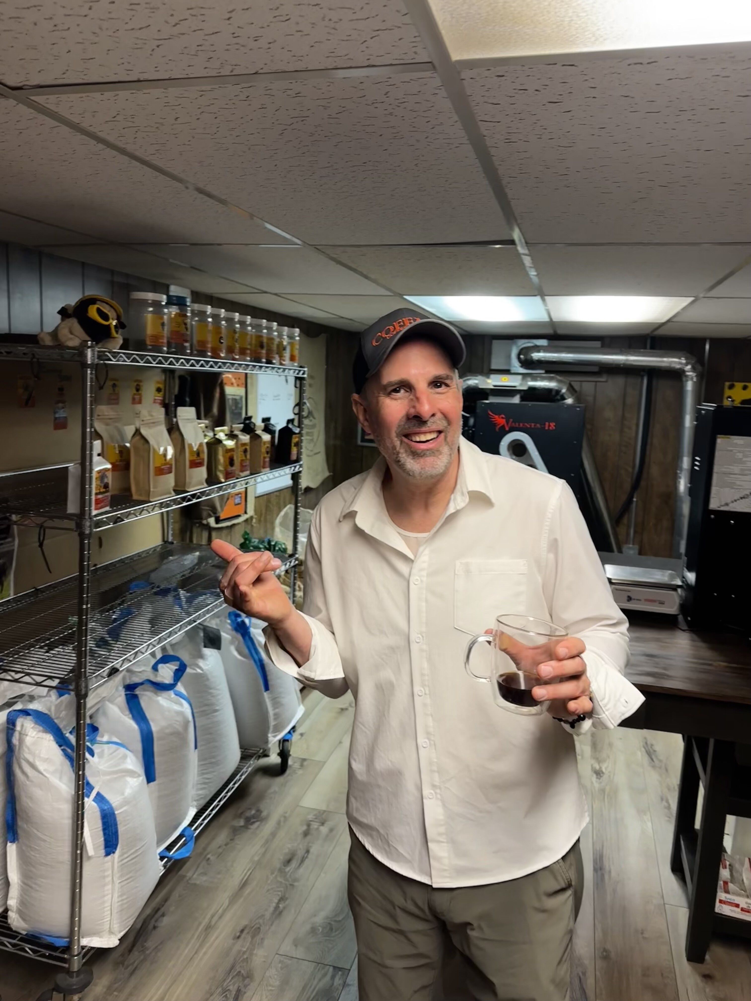 Chris James in his brew space with bags of coffee in the background