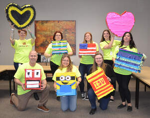 Homemakers volunteers with pinatas for childserve