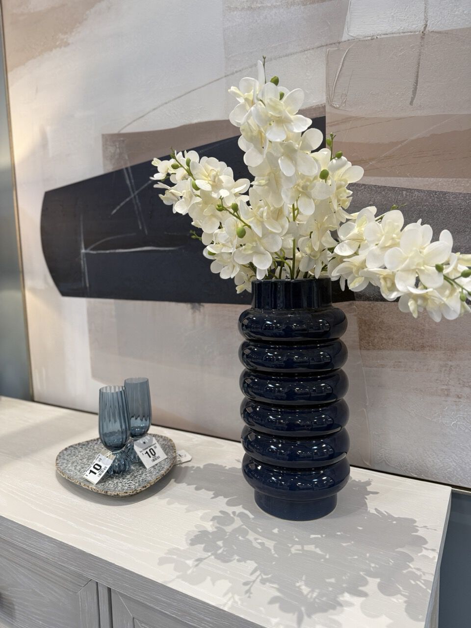 arrangement with blue vase and white florals