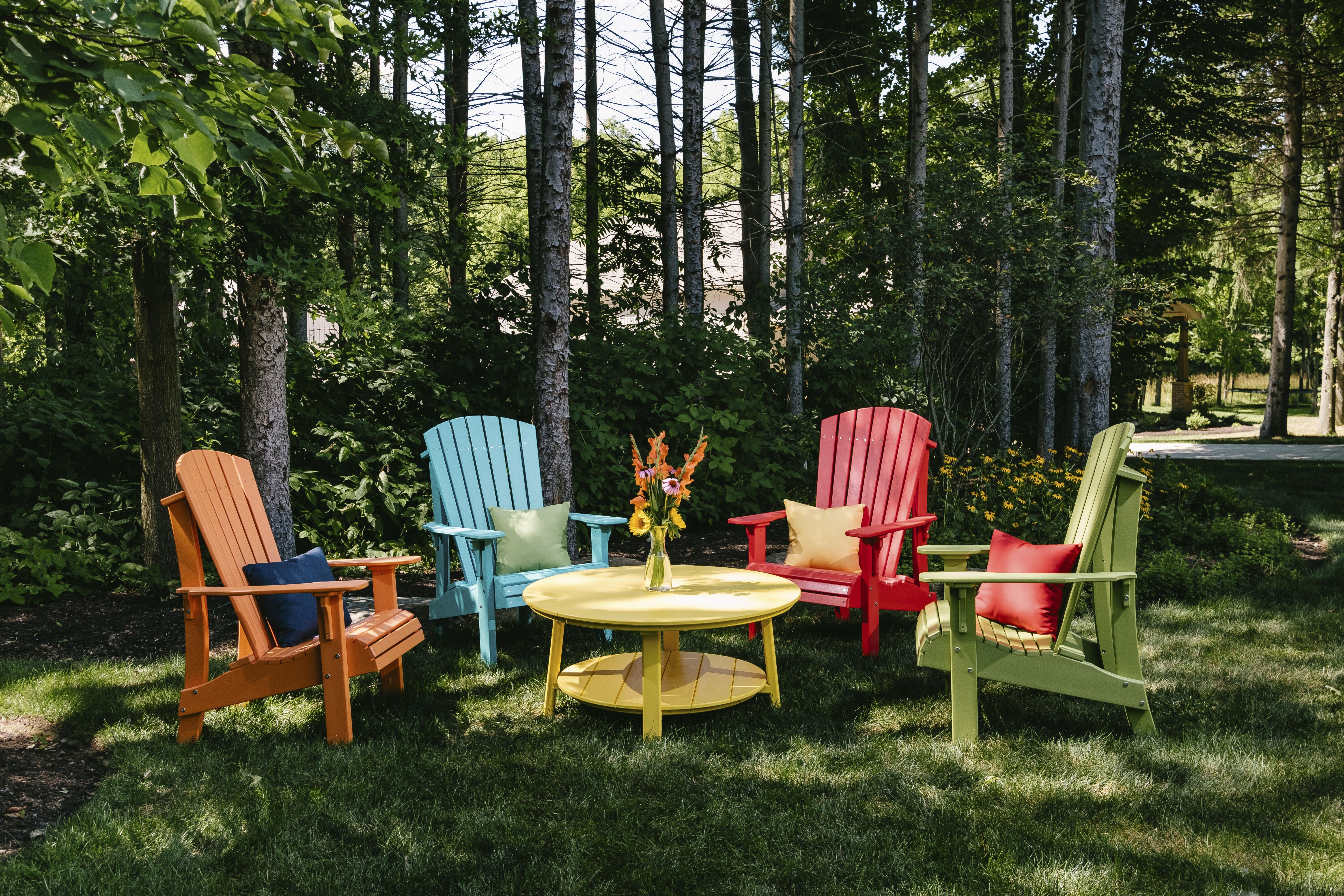 Adirondack chairs with center table and throw pillows for comfort