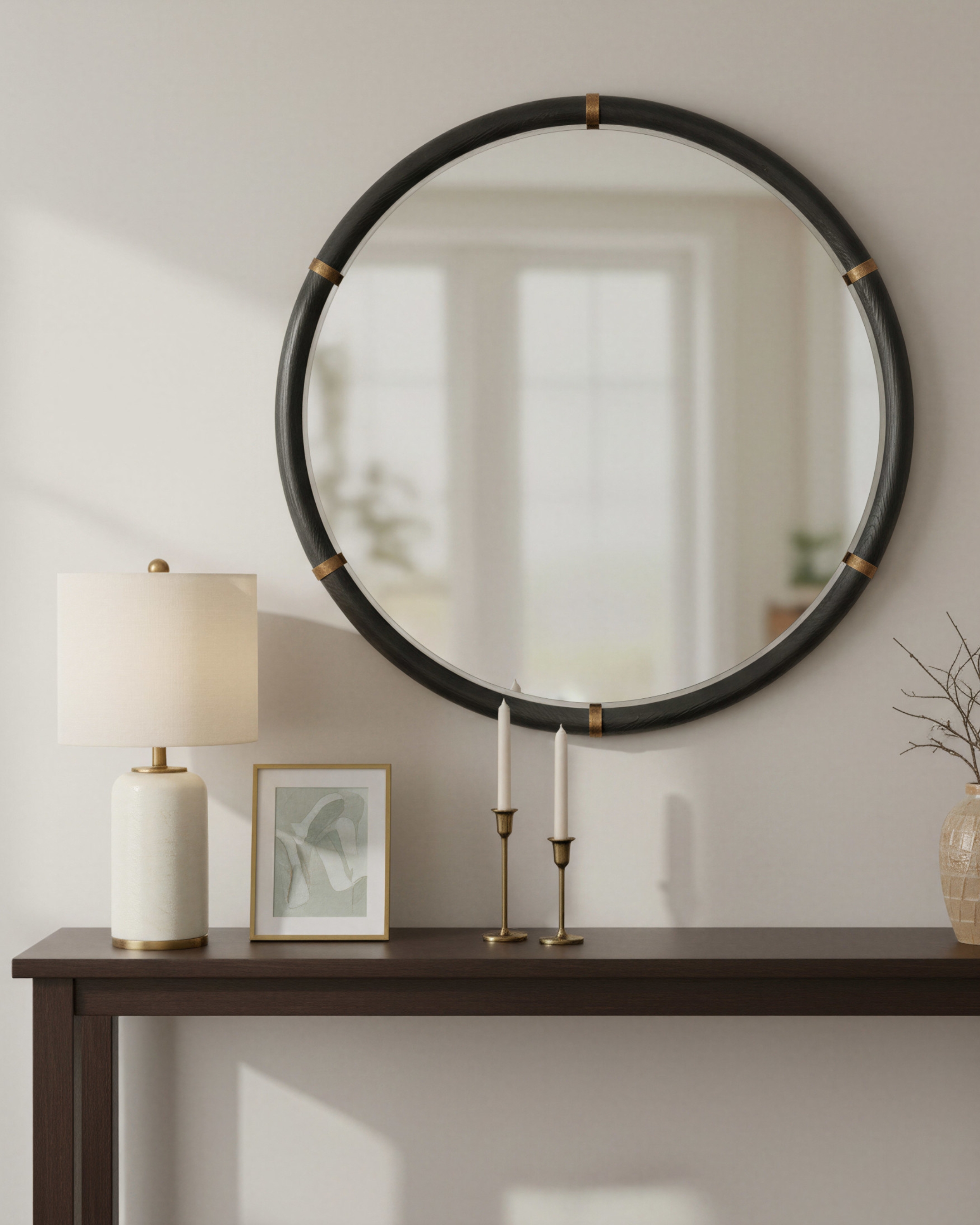 round mirror above an entryway table
