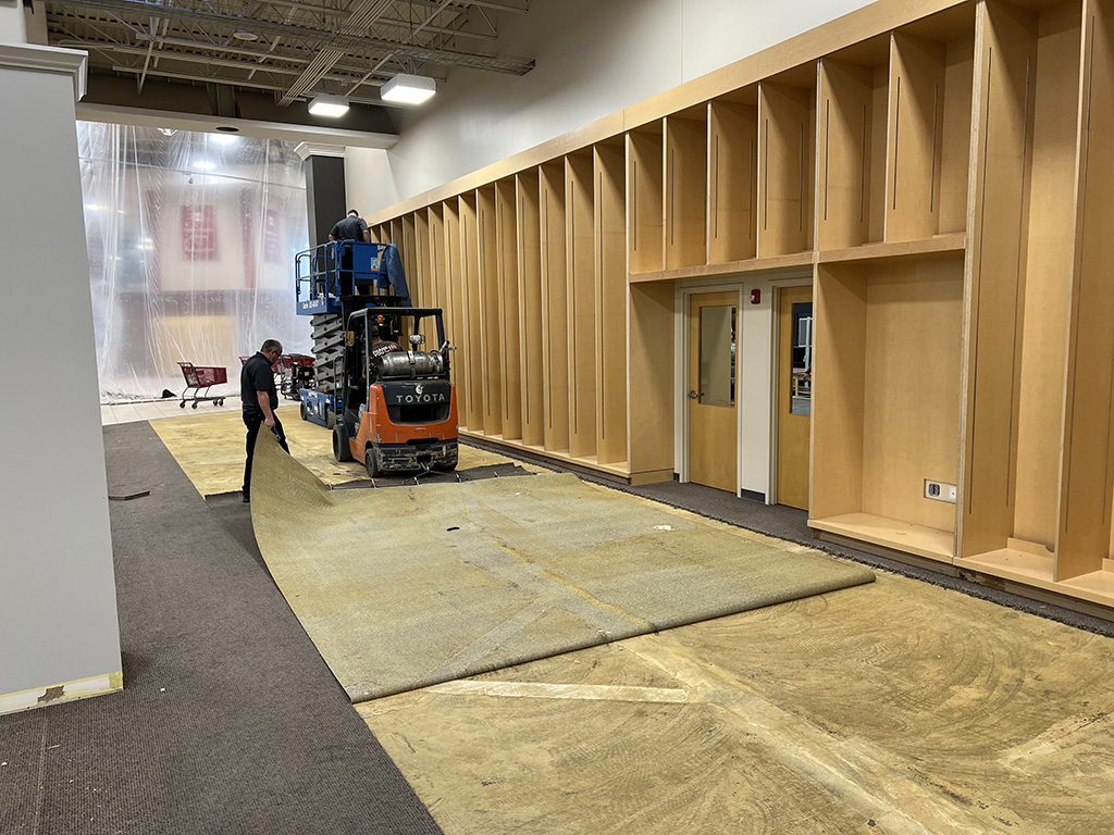 employee laying flooring