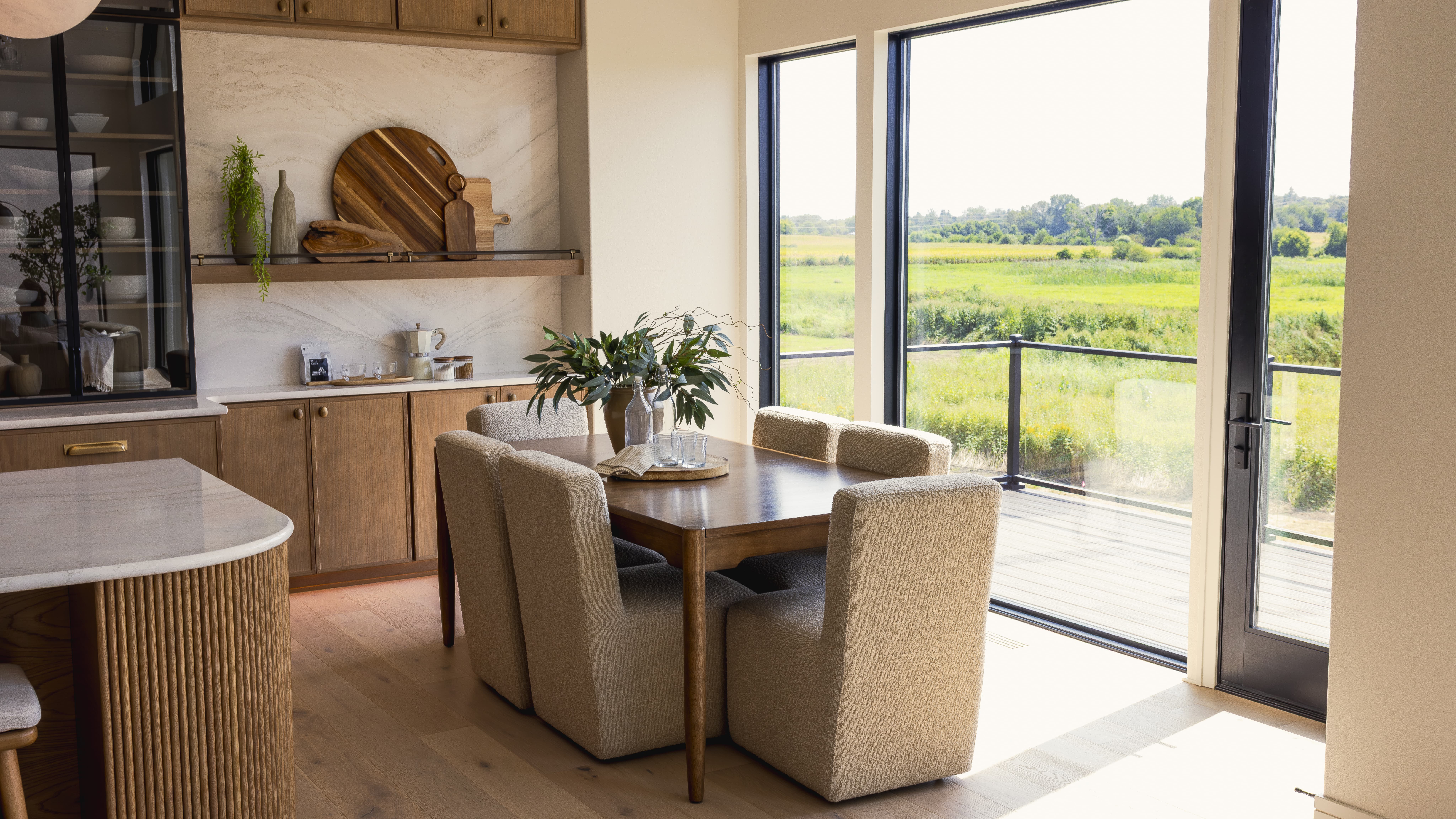 Warm but neural kitchen space with green field view from window
