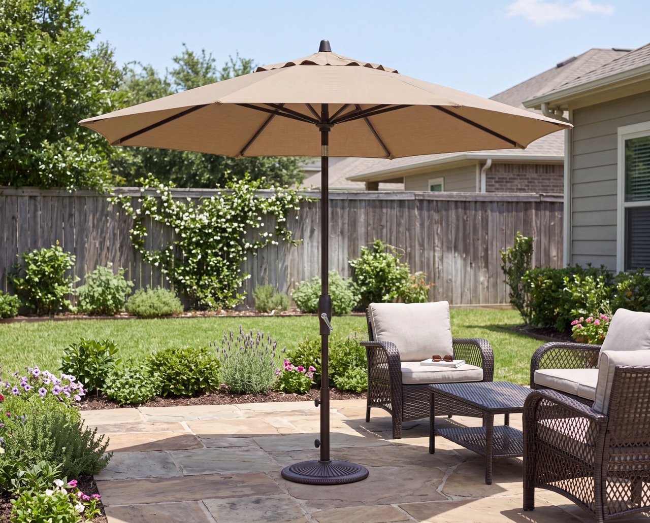 9ft tan outdoor umbrella providing shade to two chairs in a backyard patio area