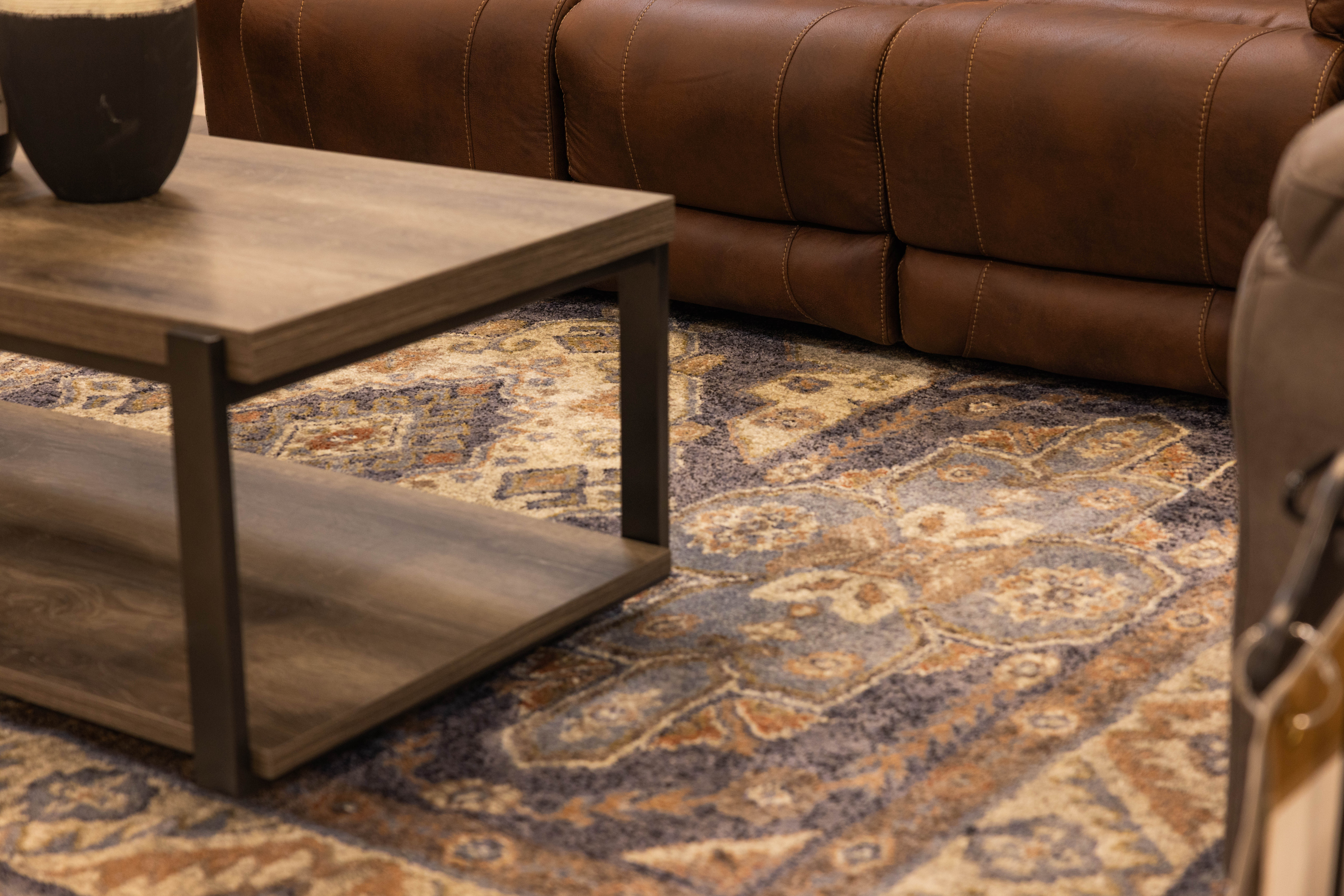 Dark blue print rug near leather sofa