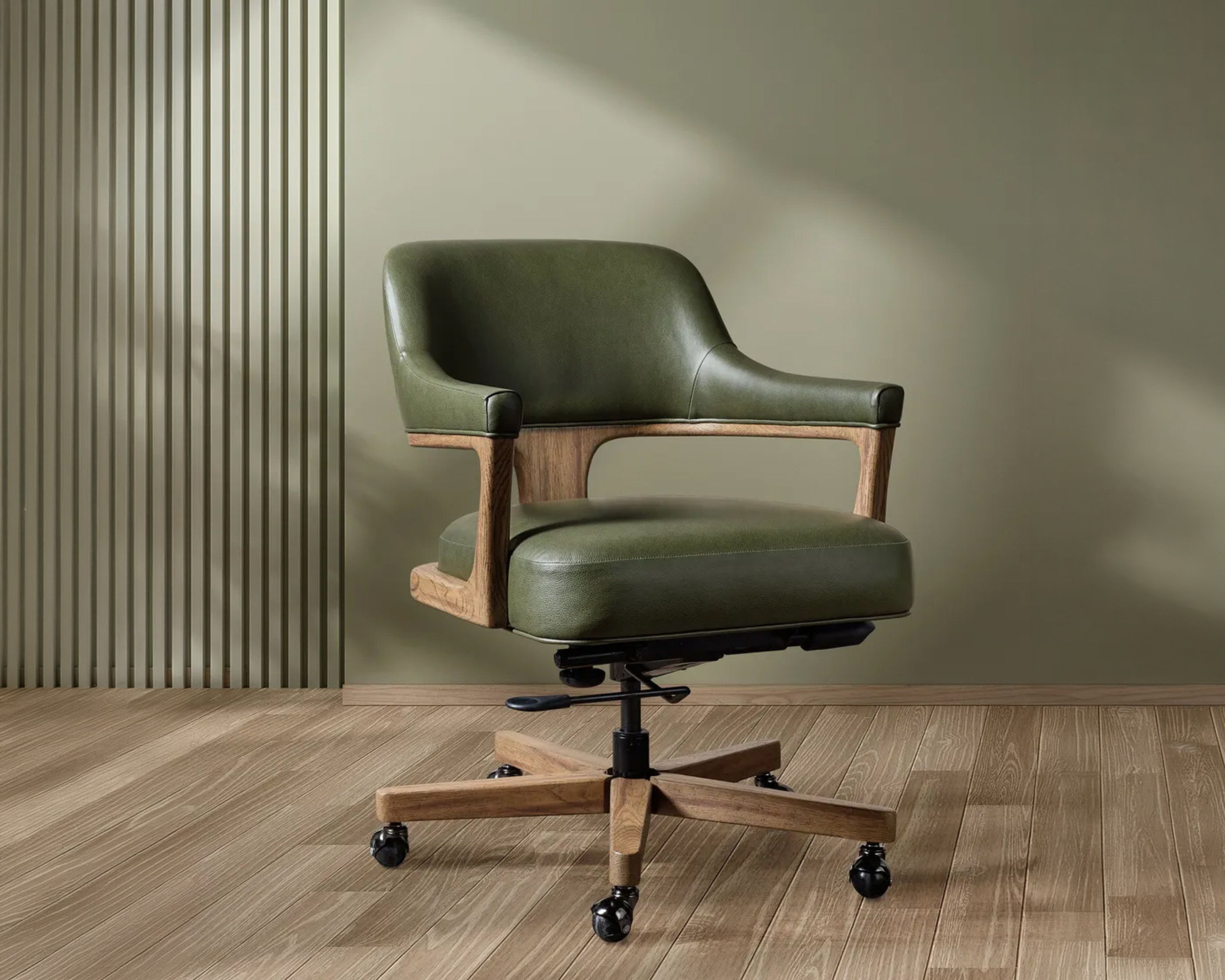 olive green office chair styled next to a green accent wall