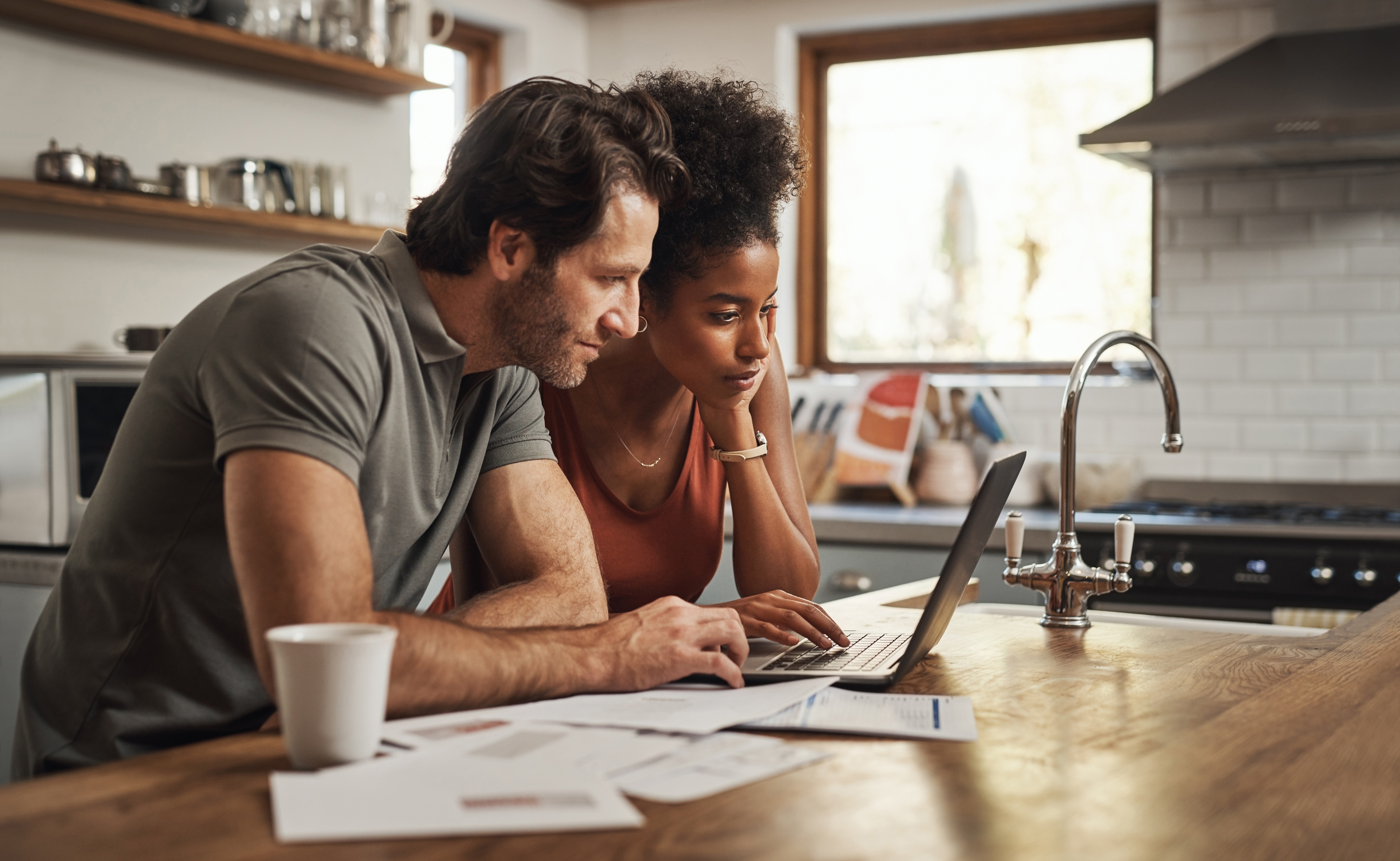 Couple at laptop planning room design