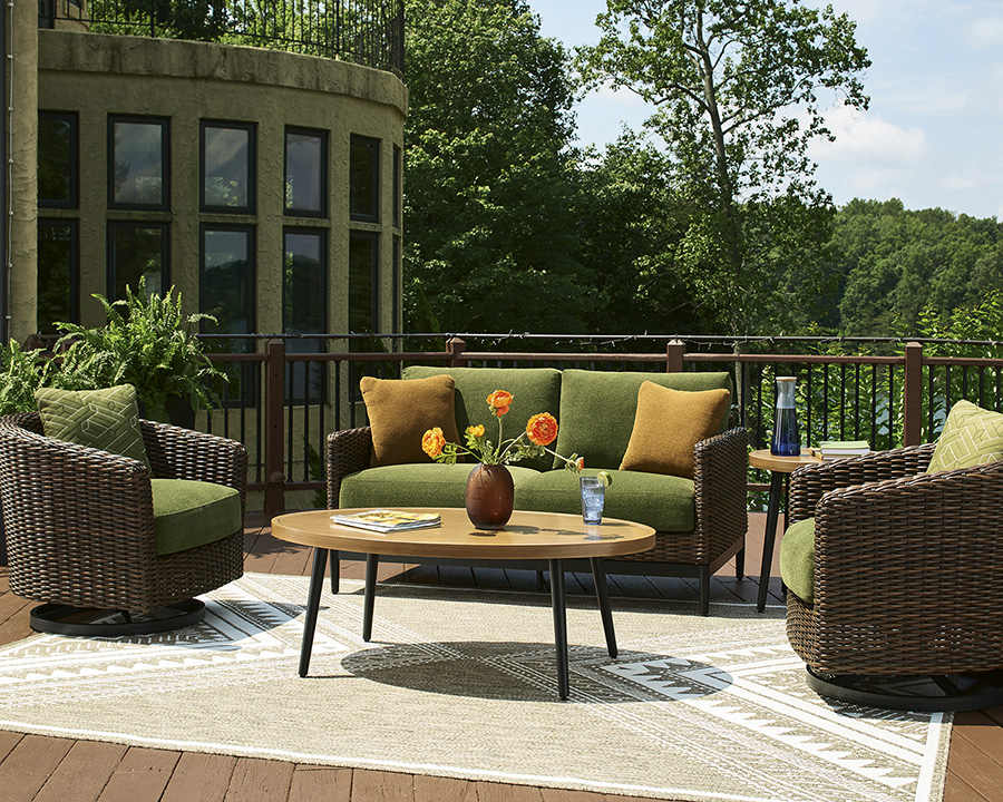 green outdoor loveseat and two swivel chairs