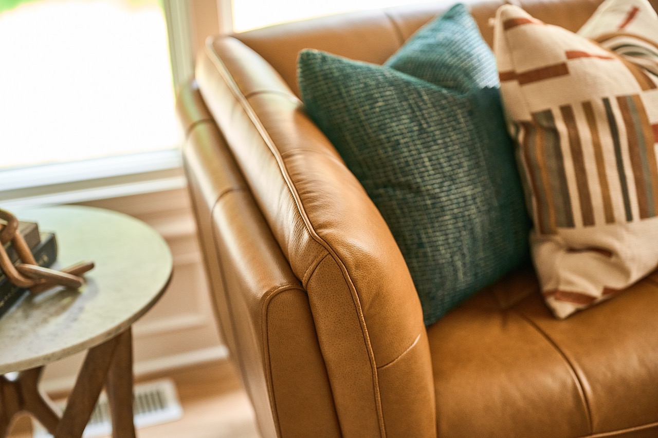 detailed photo of a leather couch with throw pillows