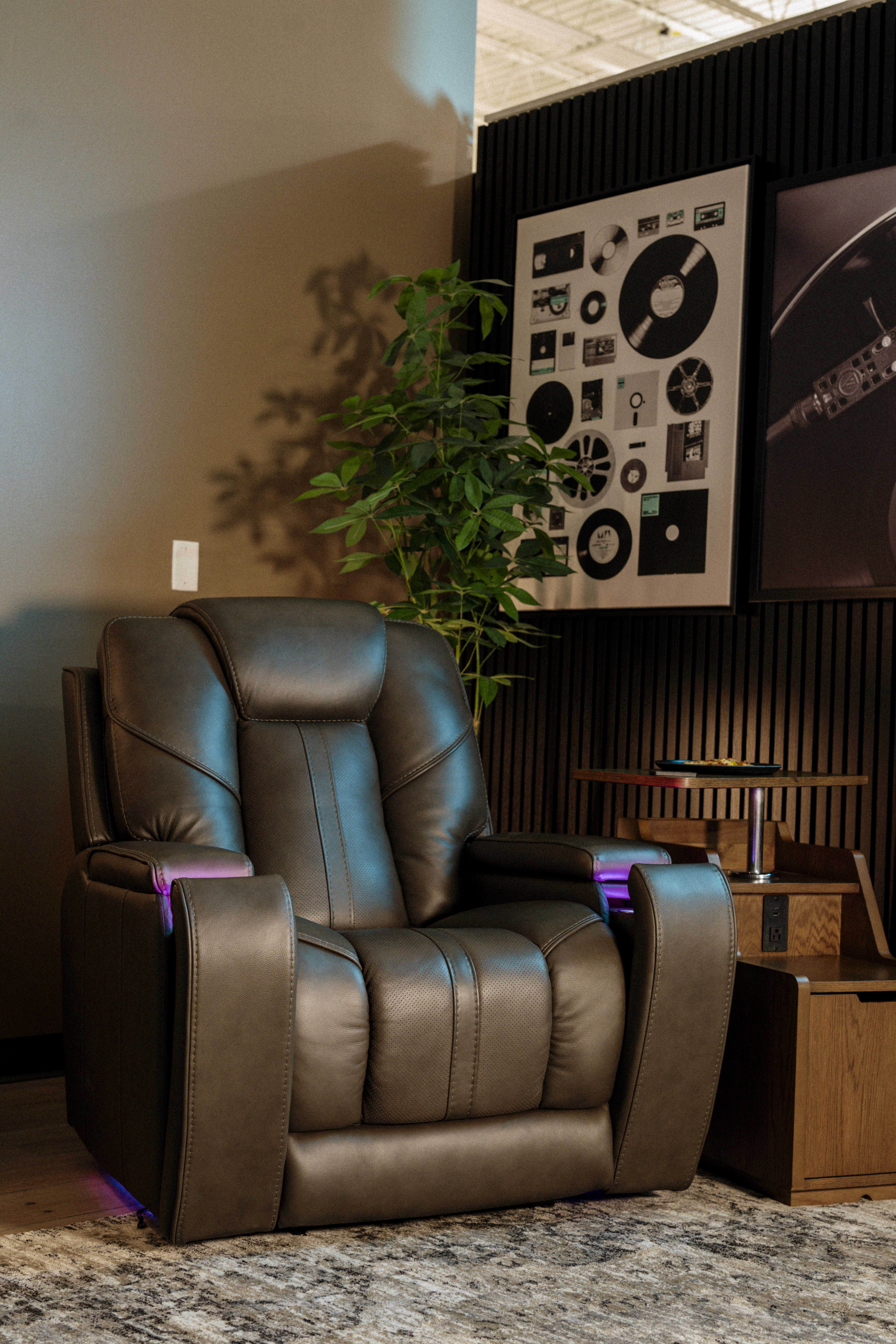 recliner in a personal nook with wall art and dimed lighting