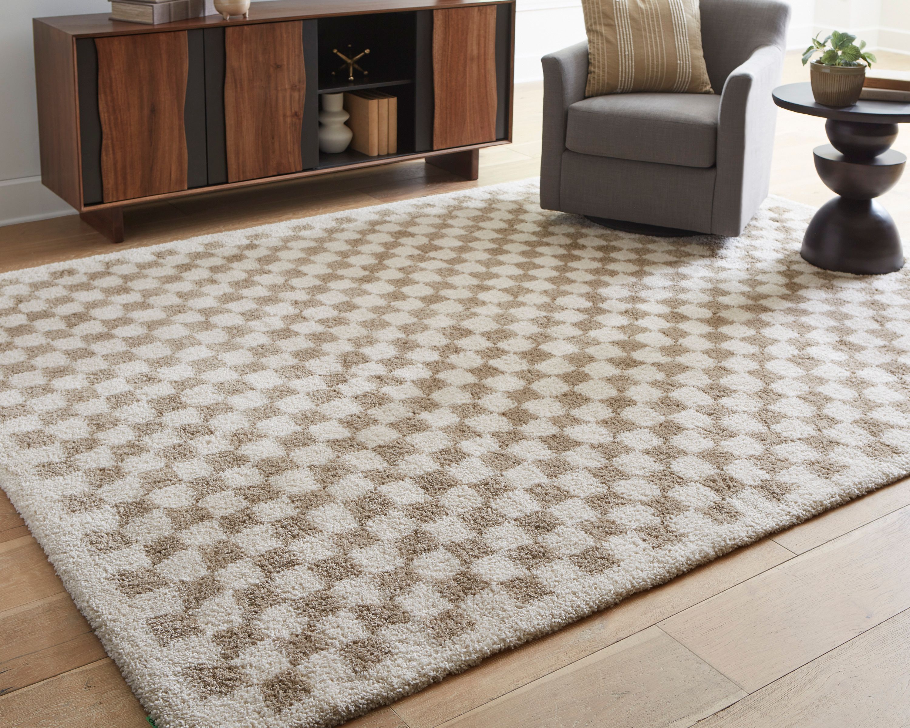 soft 5x7 checkered rug in neutral colors styled in a room