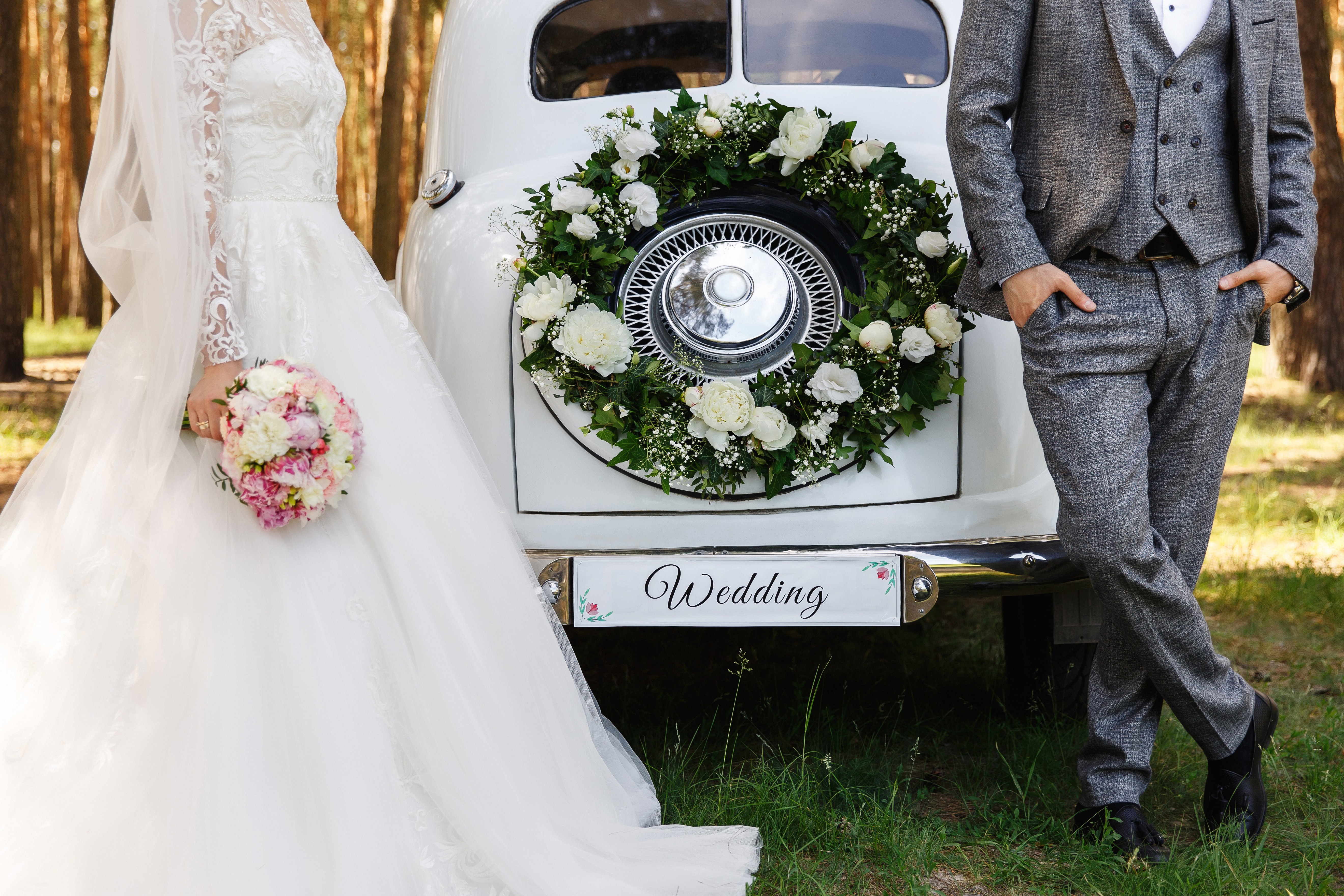 Newlyweds with vintage car.