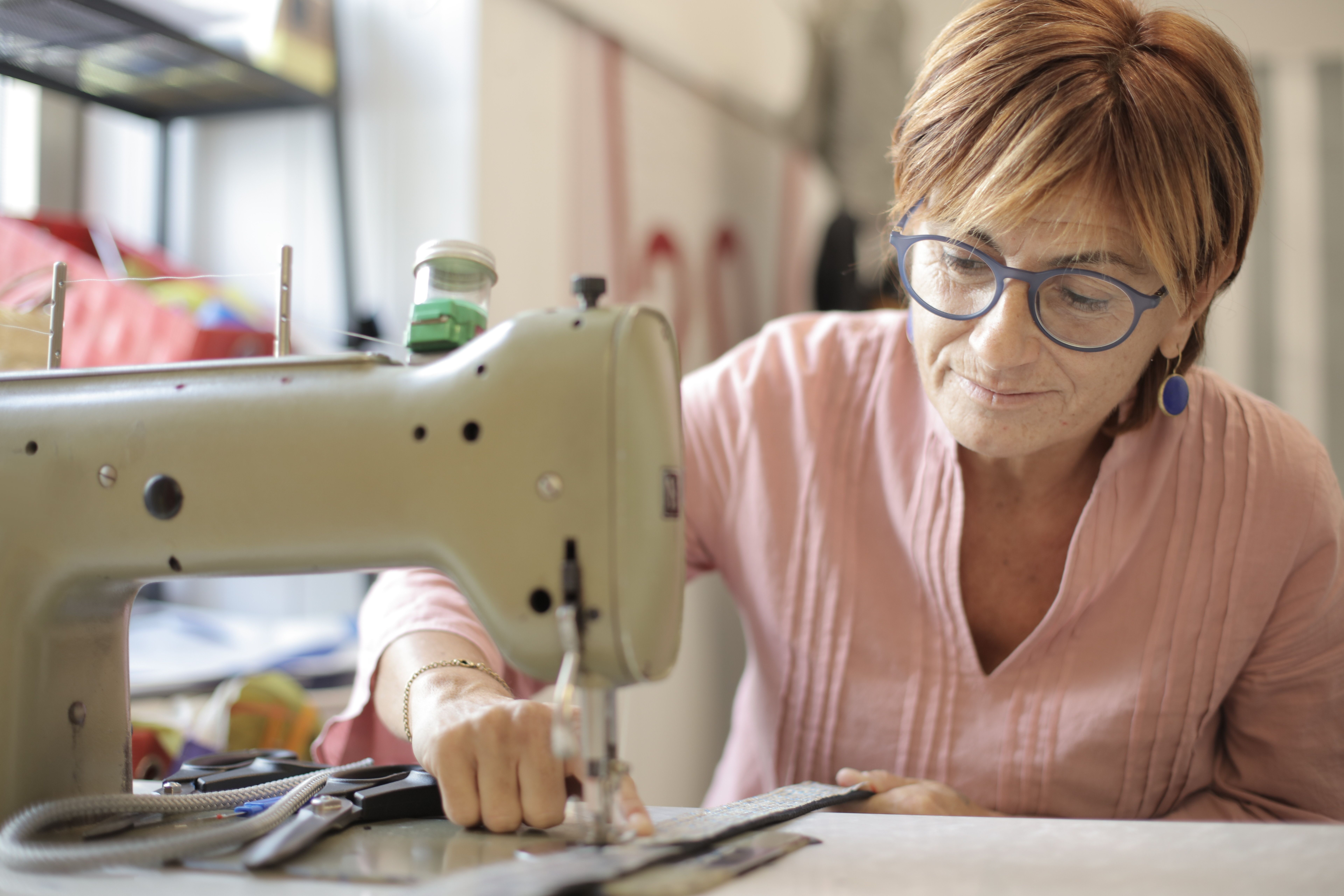 woman sitting at sewing machine