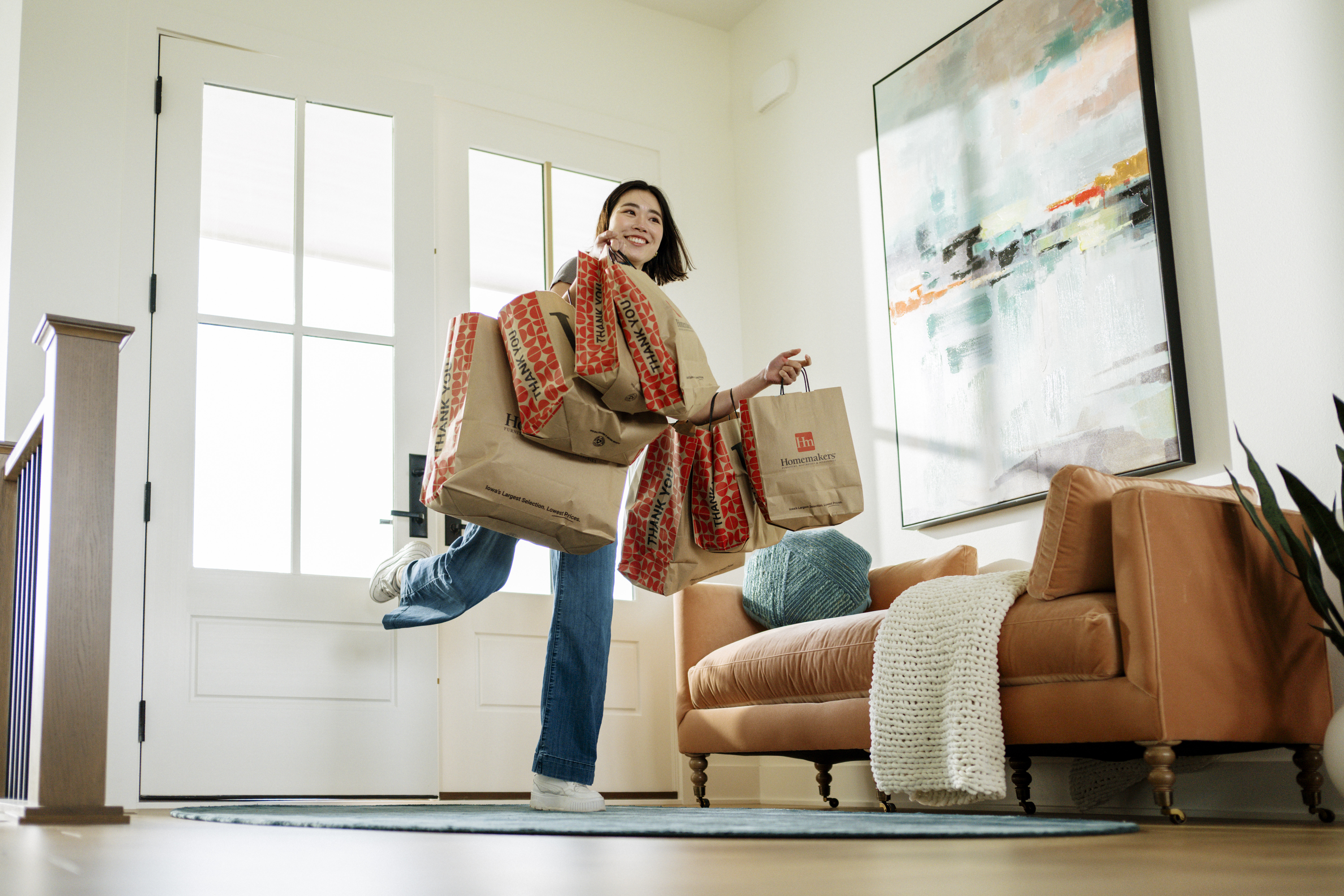 a new renter coming home with seven homemakers furniture store bags