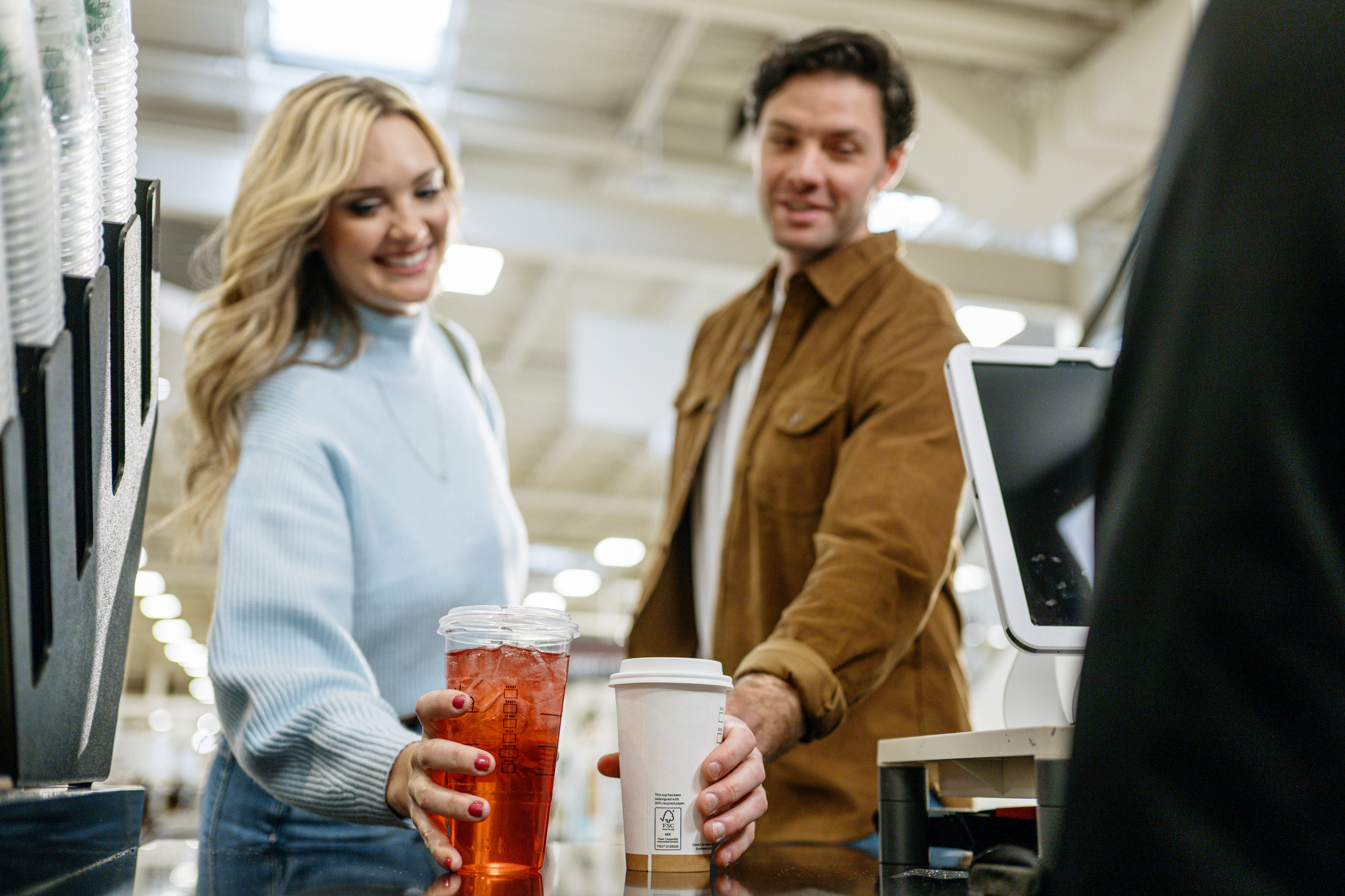 customers picking up their beverages at HOMEgrounds café