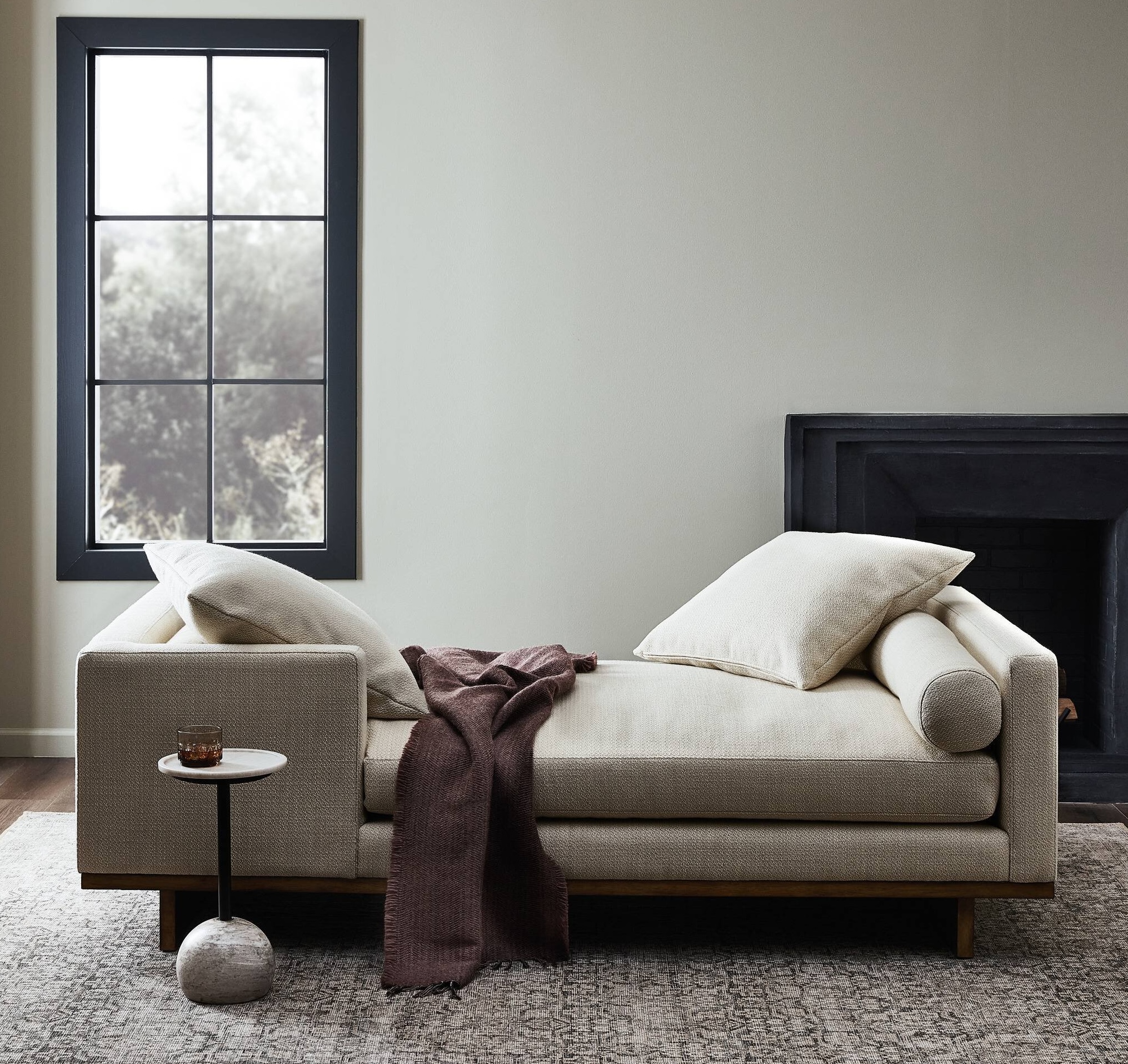 elegant taupe chaise with a blanket draped over it