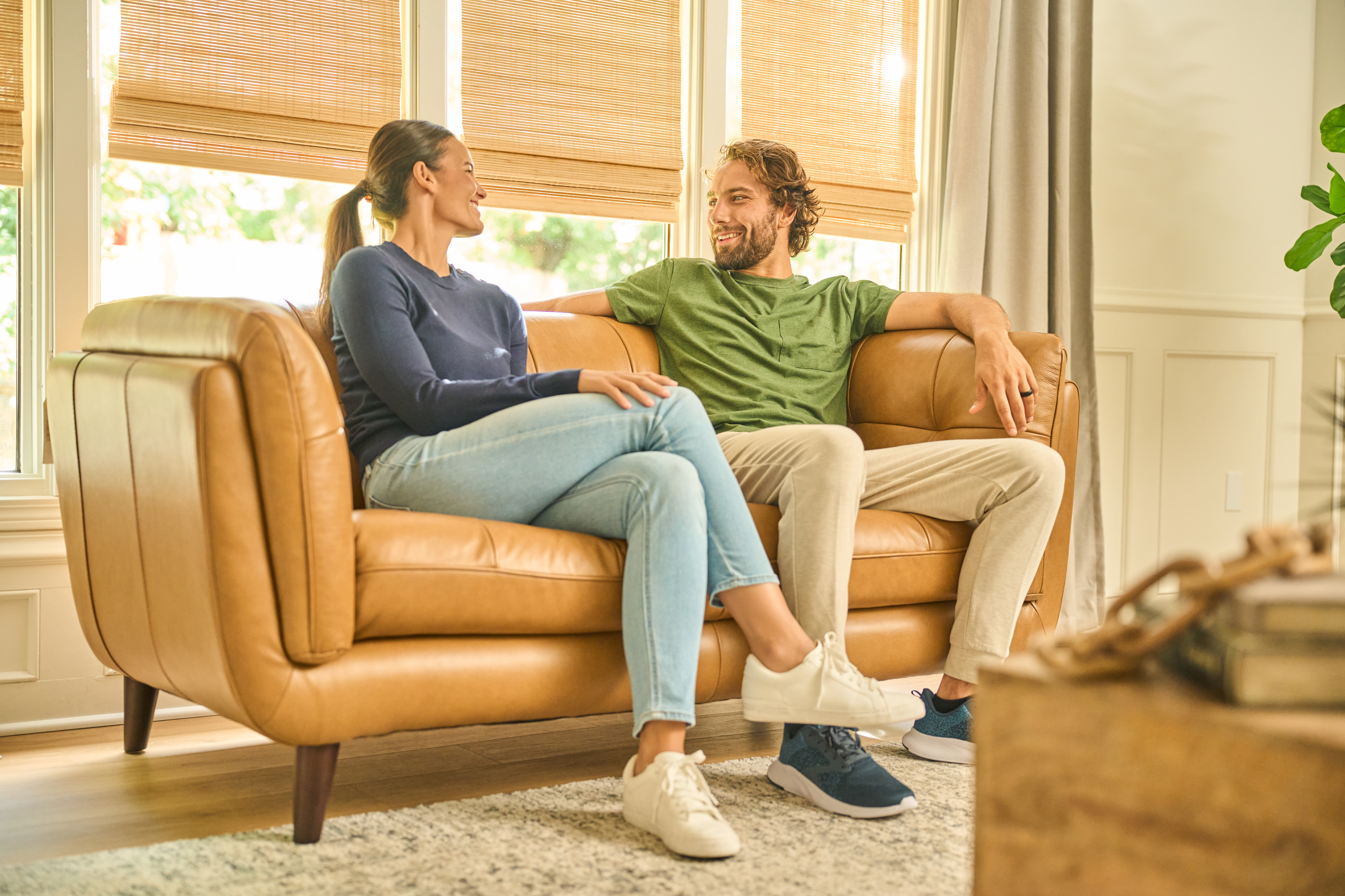 Couple on tan leather loveseat