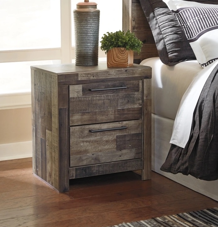 Bedroom nightstand styled beside a bed