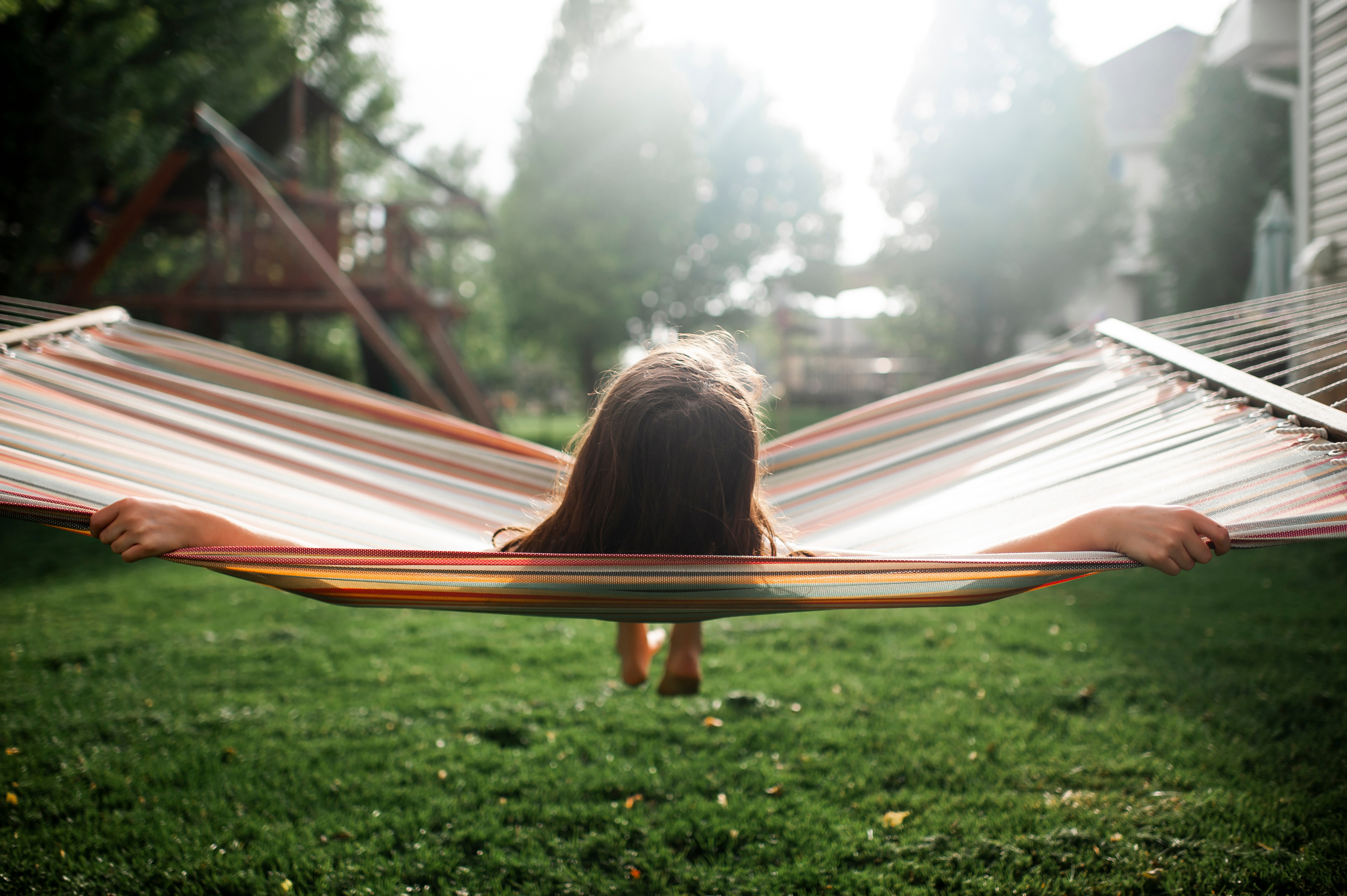 Young girl enjoying the summer sun in a hammock