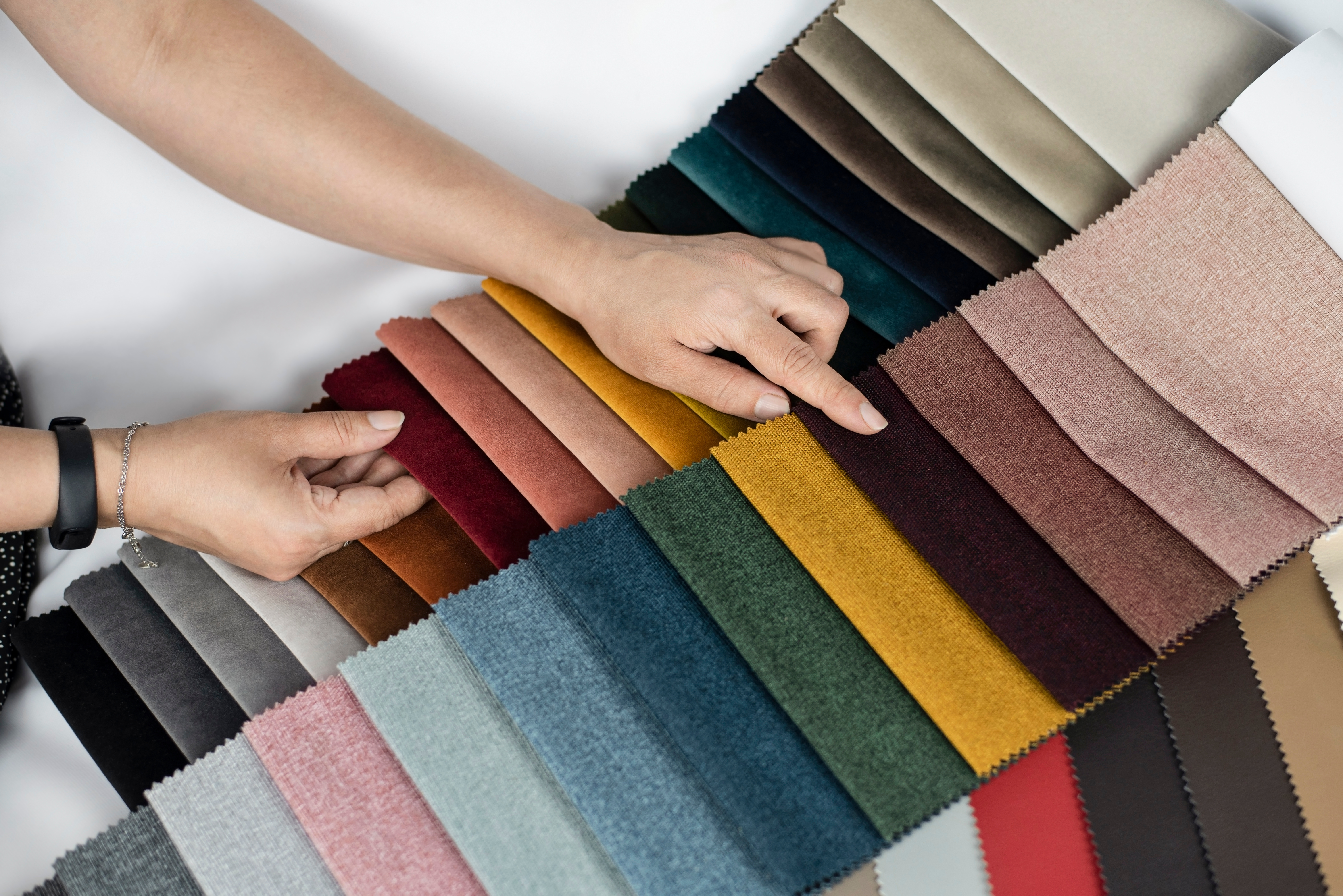 person browsing various upholstered fabric options