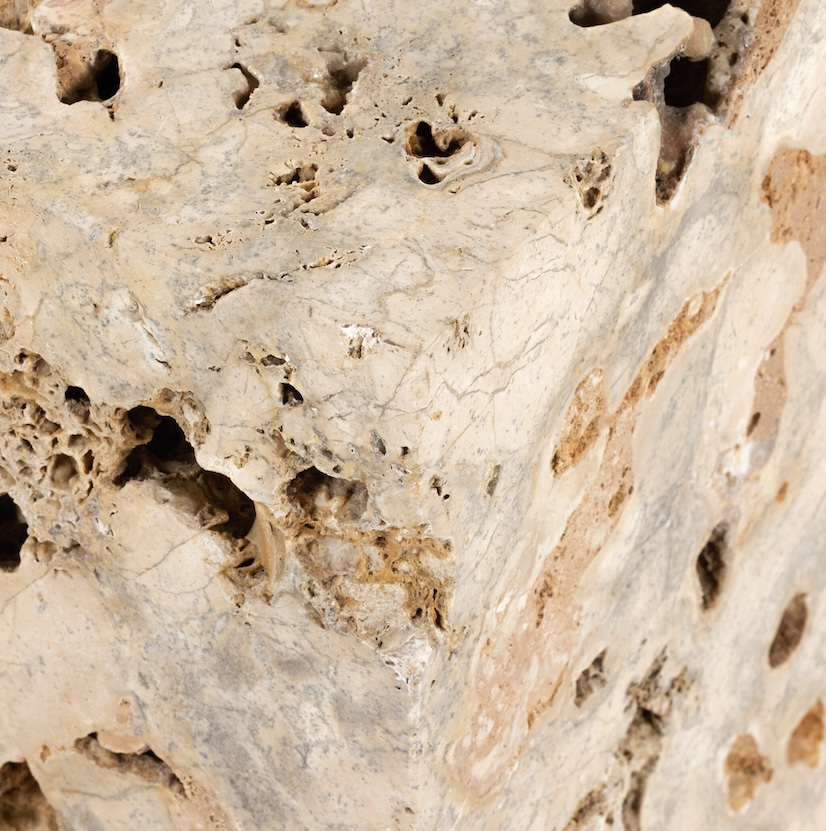 zoomed in texture and variation of a travertine stone table