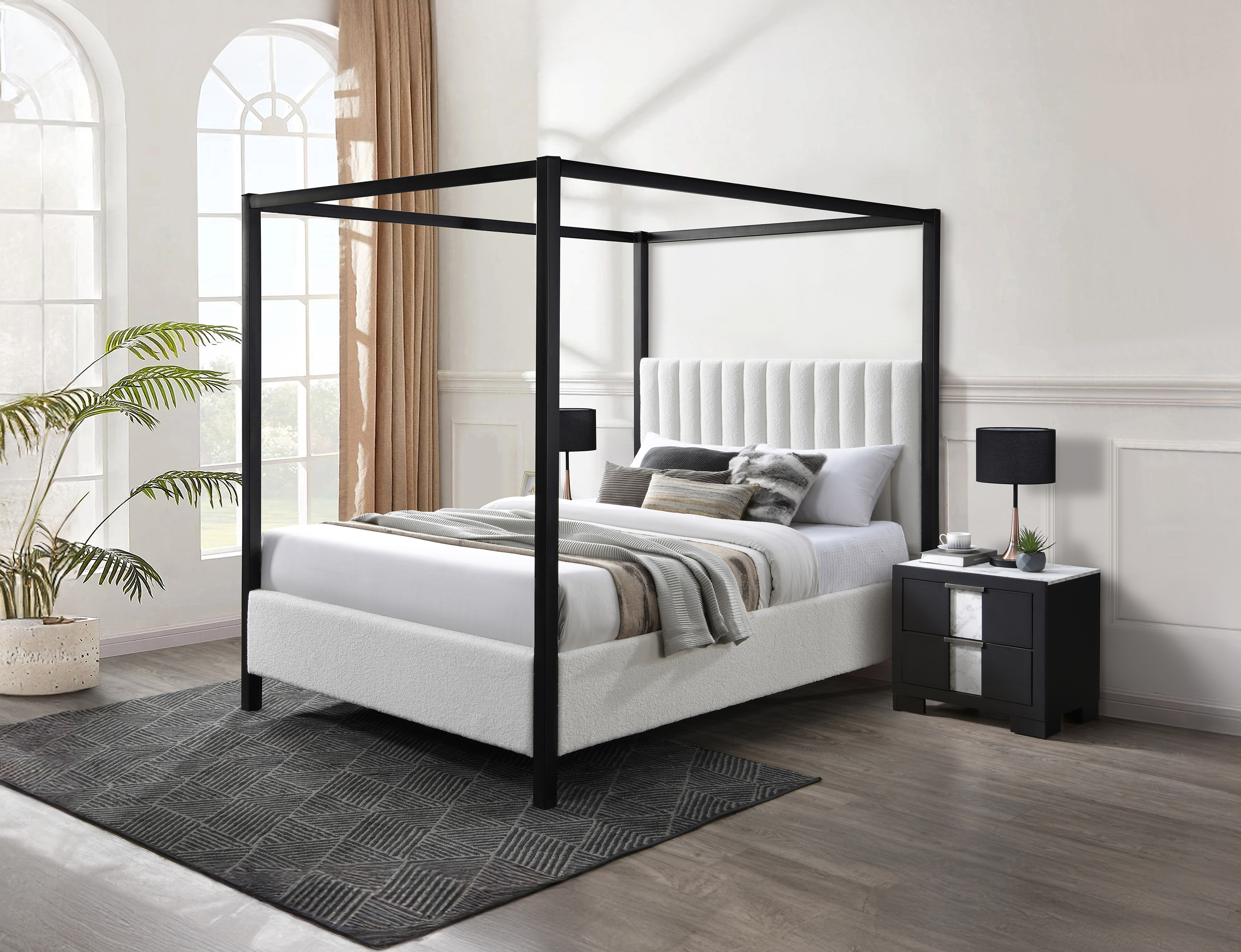 contemporary canopy bed with black metal frame and plush white upholstery 