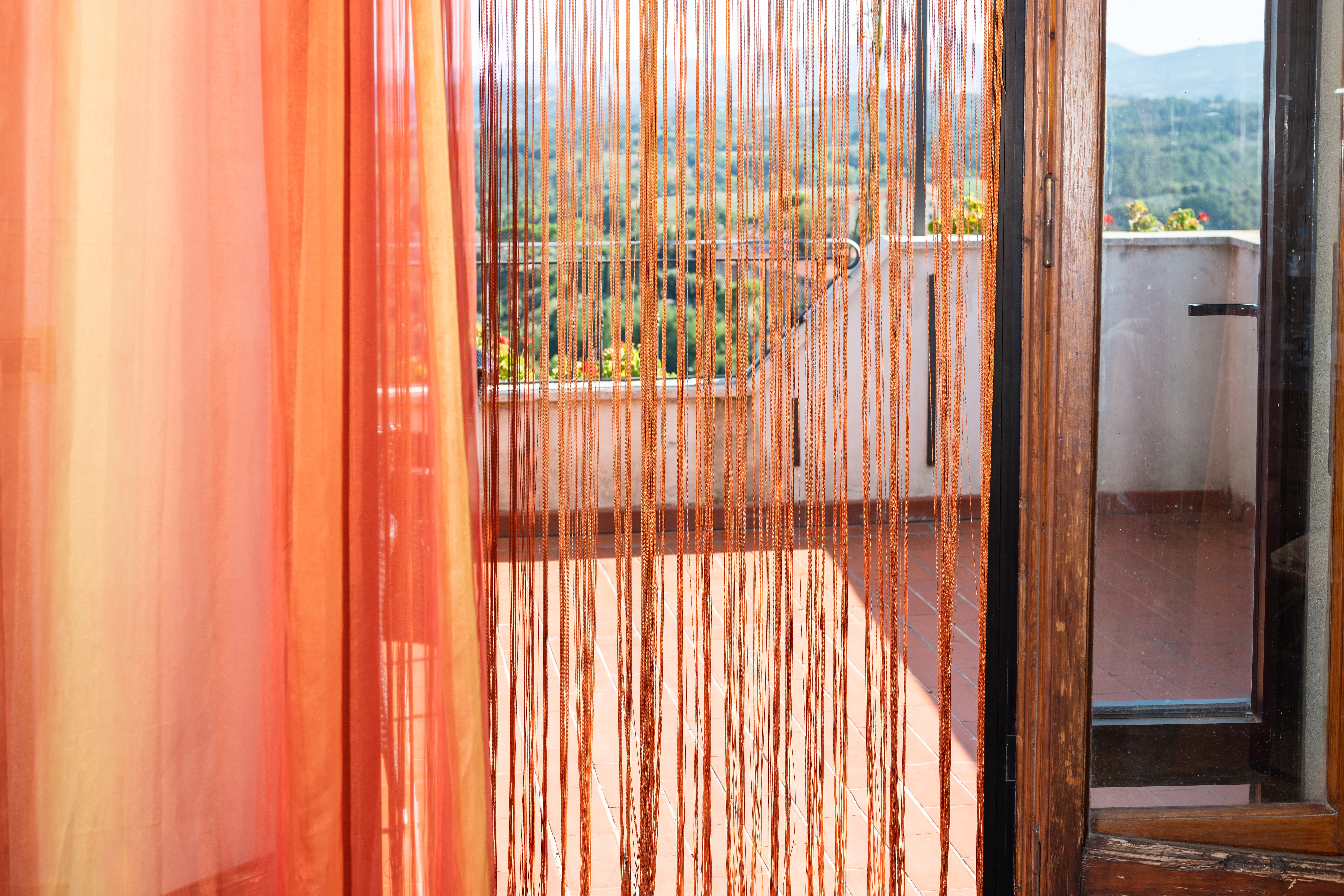 Soft orange curtain separating space