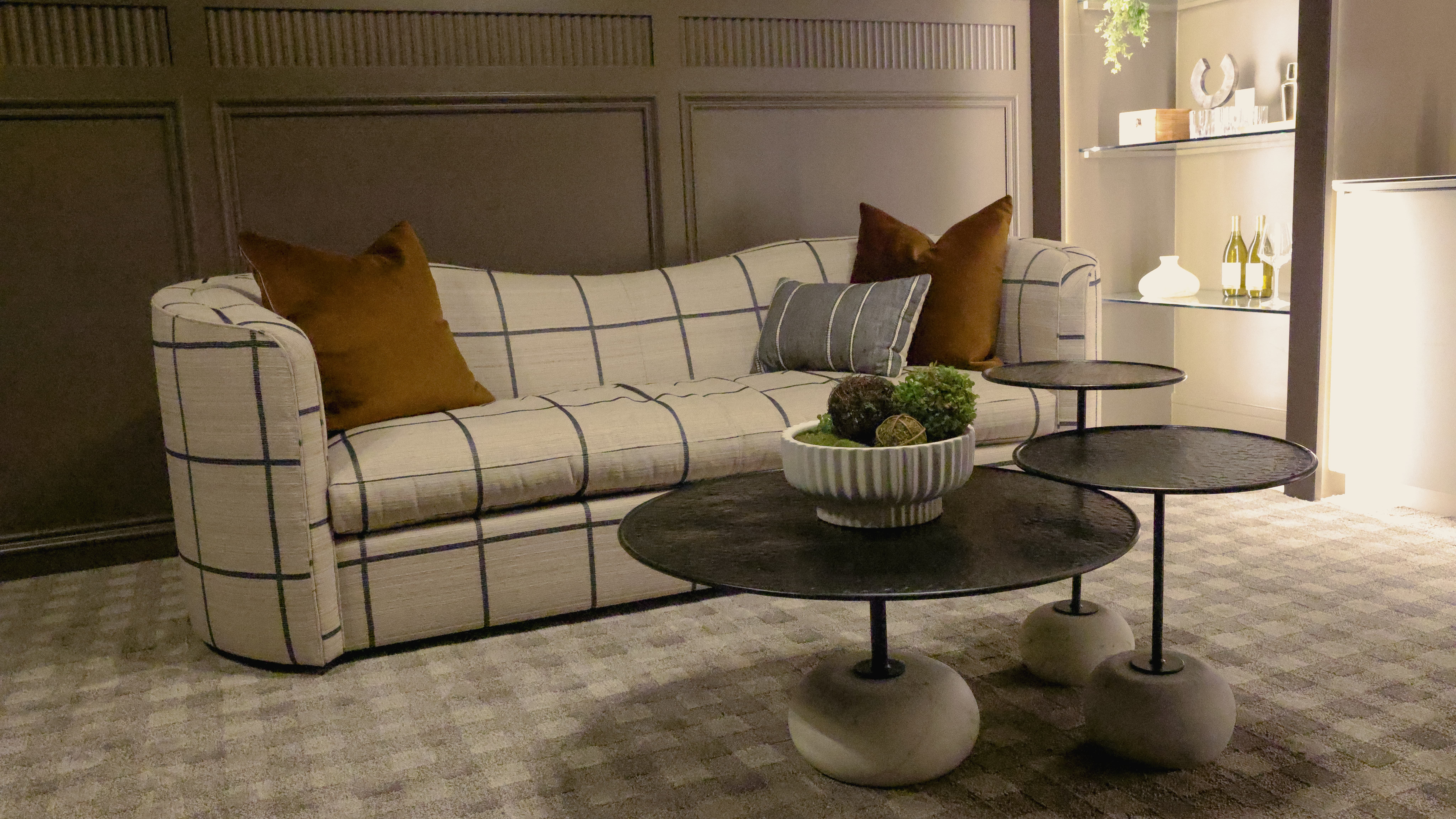 Curved natural sofa in sleek but cozy space