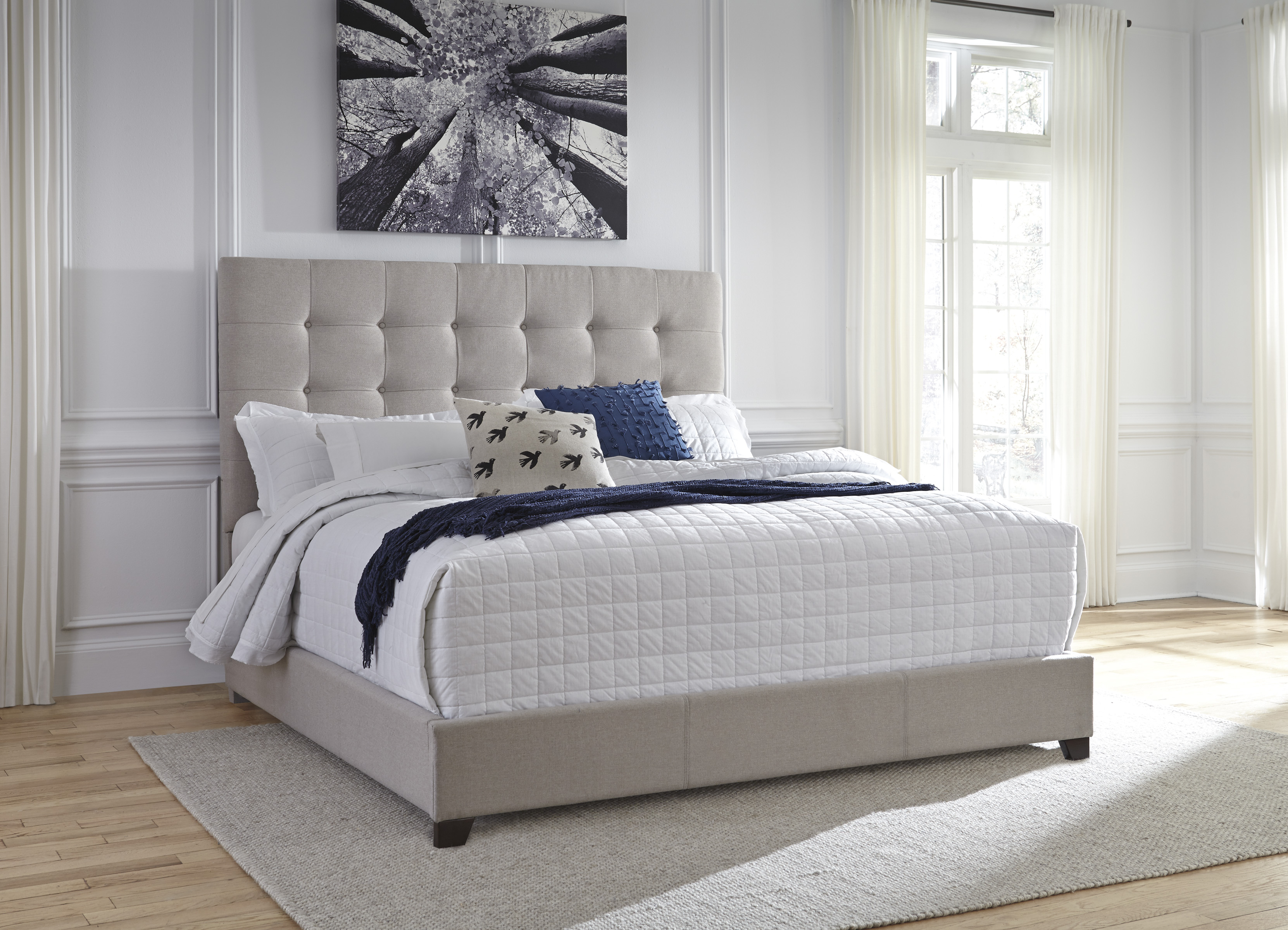 beige upholstered queen bed with button tufted headboard