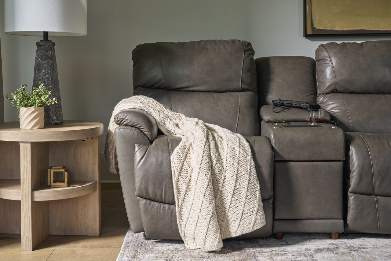 photo of a casual upholstered couch with a throw blanket