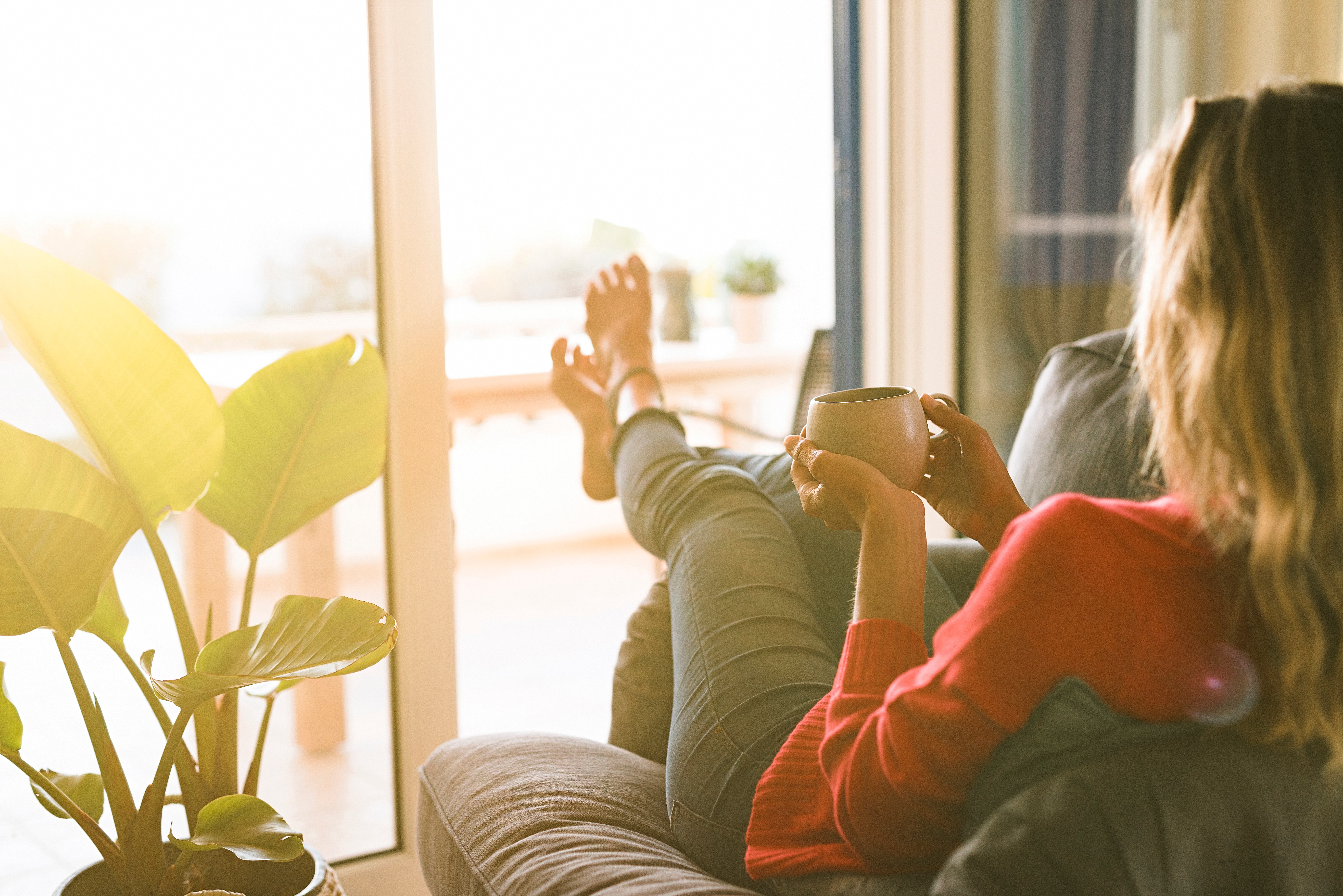 Woman relaxing on the sofa with coffee
