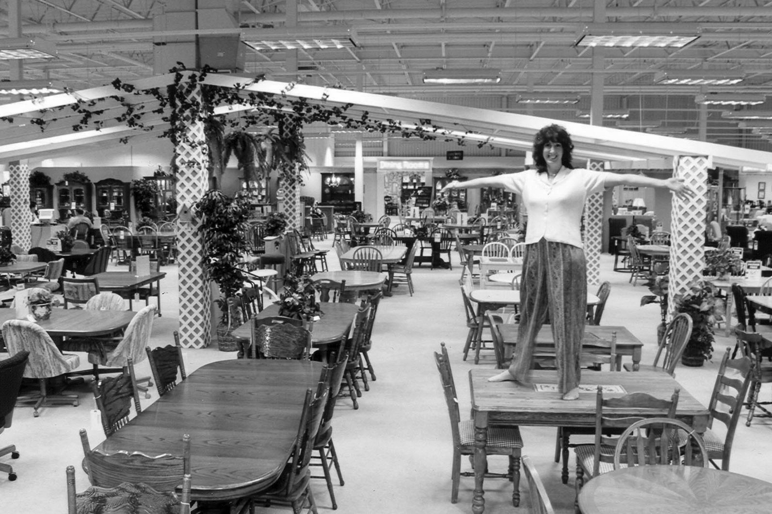 woman standing on table in homemakers