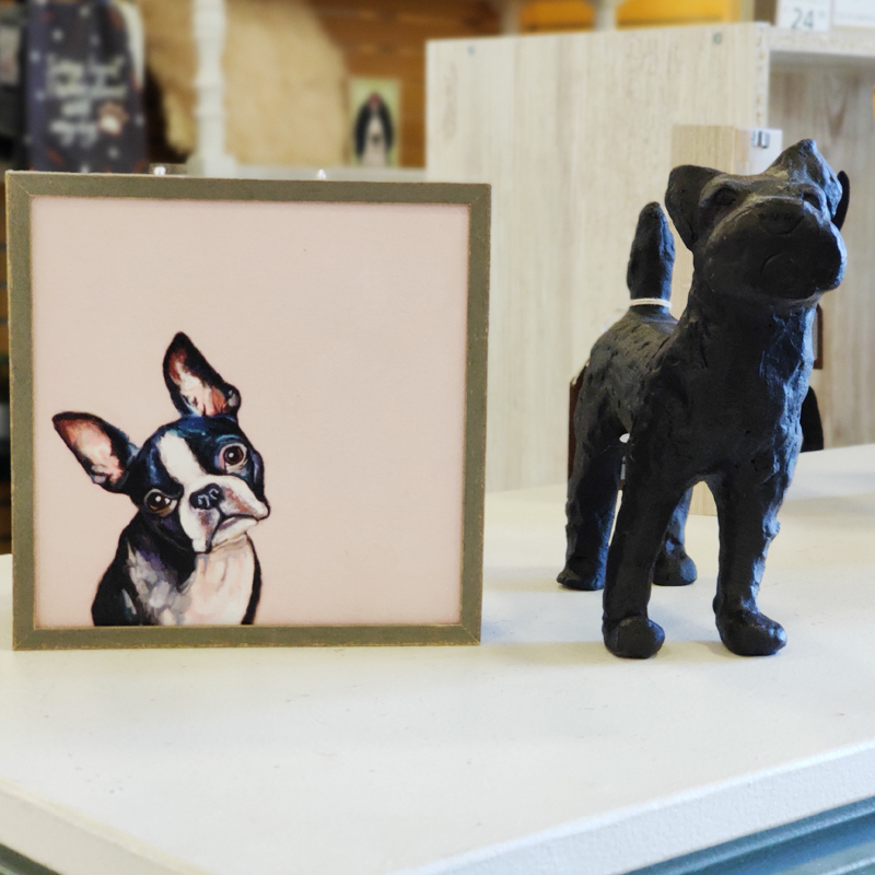 framed art of dog next to dog statue