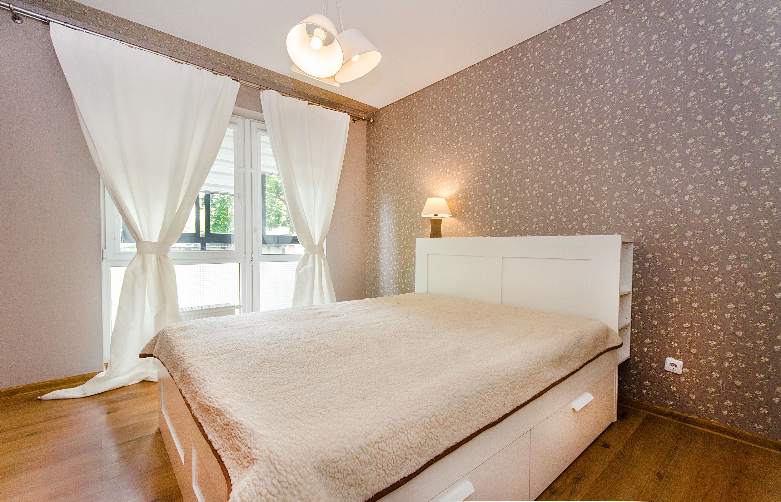 a wall painted in mauve and a focal wall with printed peel and stick wallpaper
