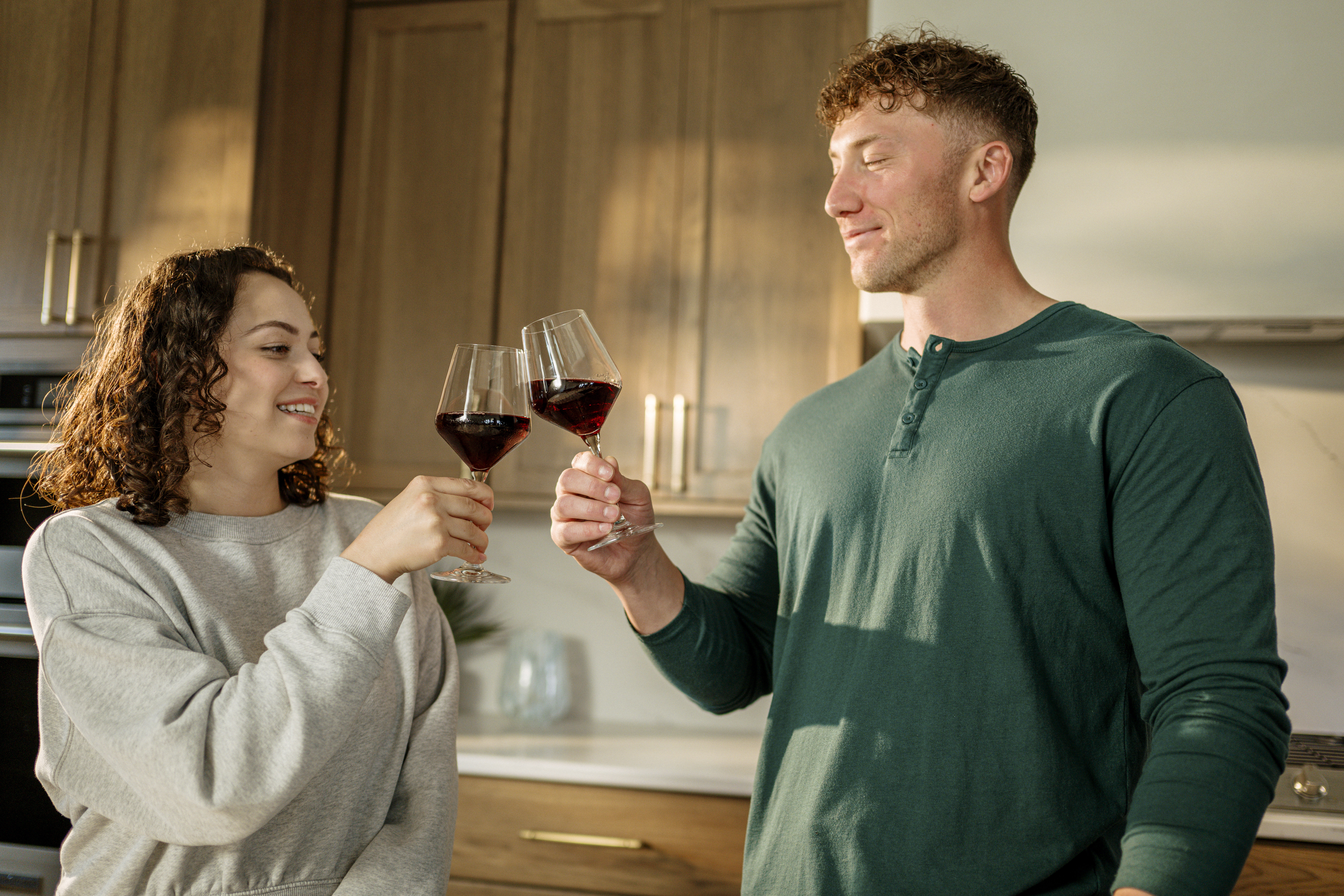 a couple toasting to their first place together