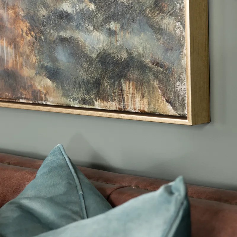 Art piece hung above sofa